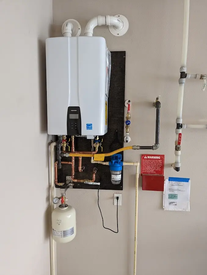 Professional plumber installing copper piping in a Wolcott home